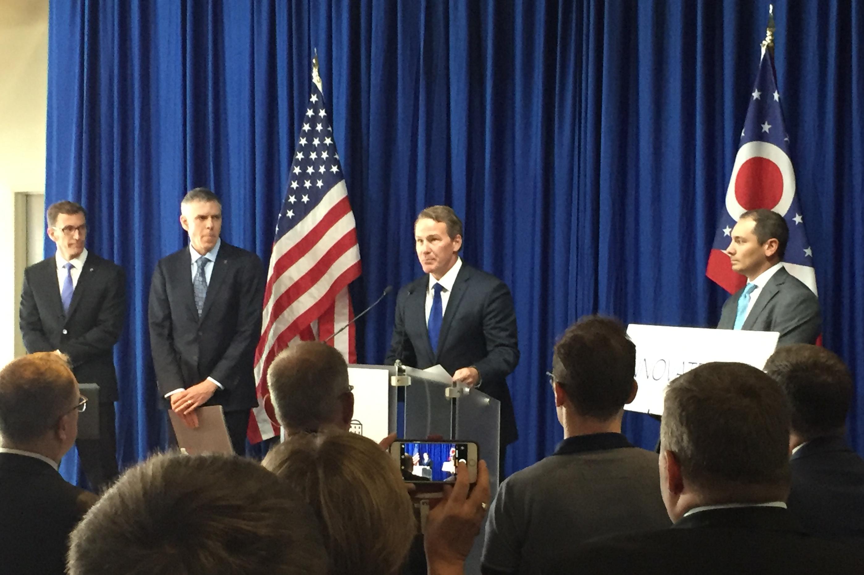 Lt. Gov. Jon Husted is flanked by Ohio's State's associate vice president of technology commercialization Kevin Taylor and others as he announces the Ohio IP Promise.
